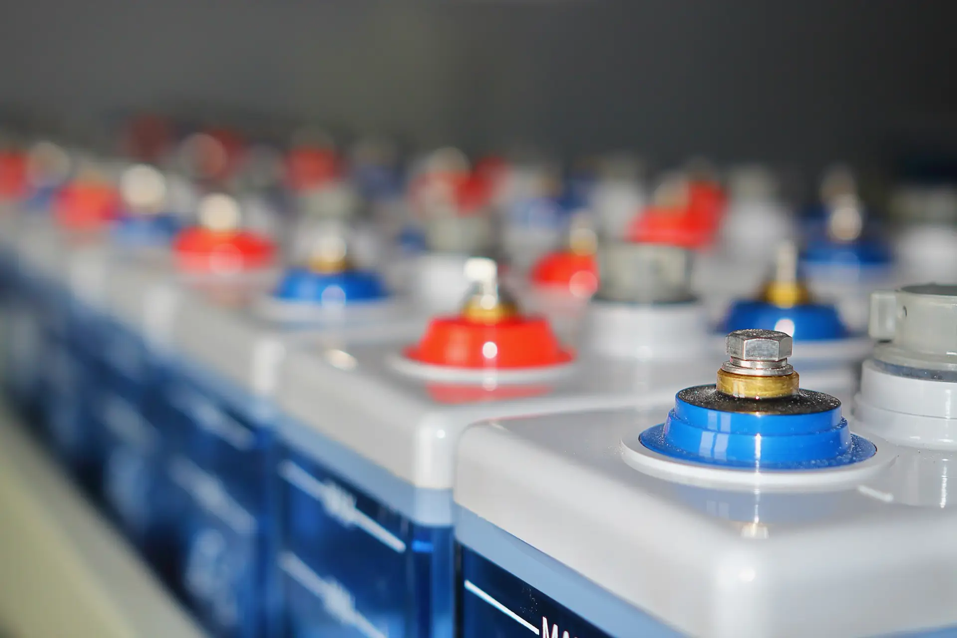 Rows of industrial battery cells with red and blue terminals, industrial battery servicing Chelmsford
