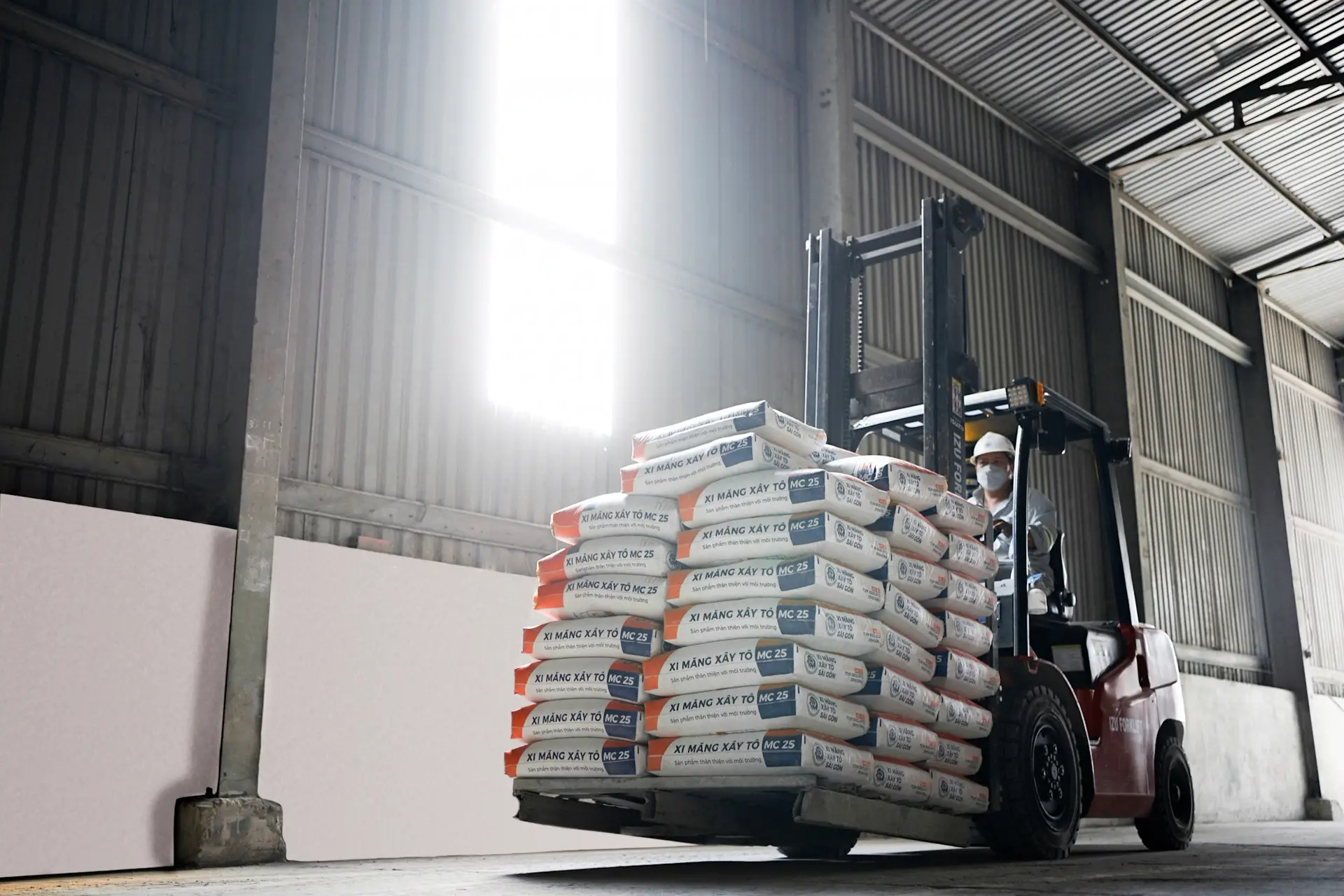 Electric forklift truck moving pallets in a warehouse, forklift battery servicing Essex