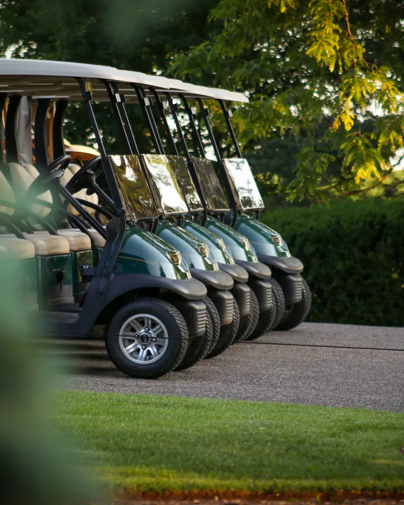 Row of electric golf buggies, golf buggy batteries Essex